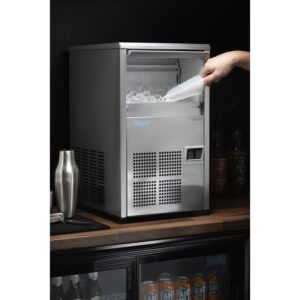 a hand pouring a bottle into a ice machine